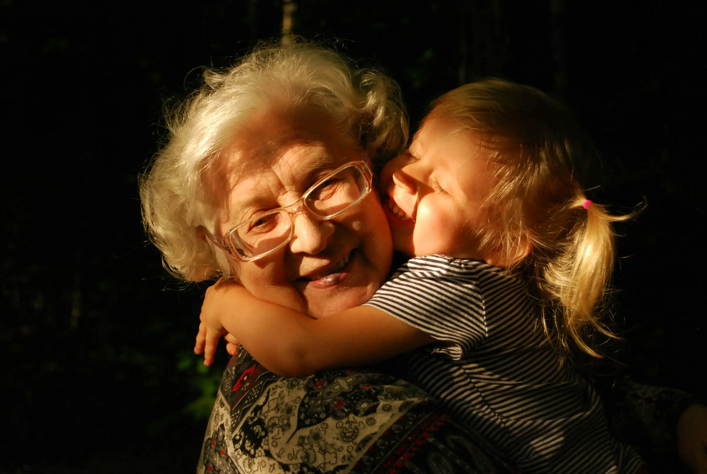 A grandmother embracing her grandchild